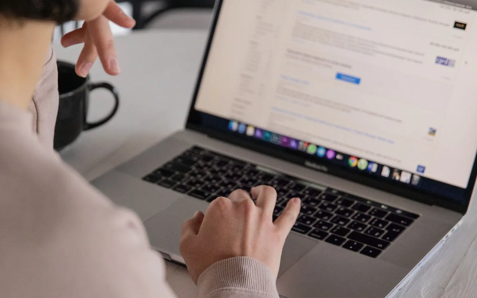 Remote worker searching for jobs on a laptop — most openings surface somewhere other than the boards first
